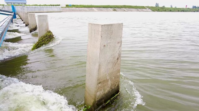 River Dam with Concrete Pillars and Flood Control Gates