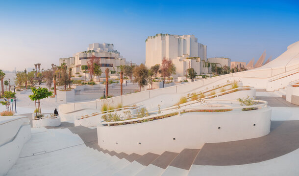 6 December 2025, Abu Dhabi, UAE: Contemporary TeamLab architecture with organic forms, winding stairs, strategically placed trees, and green plants framing a cafe entrance