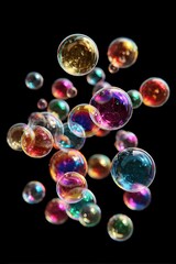 Fototapeta premium Vibrant colorful bubbles floating in mid-air on black background