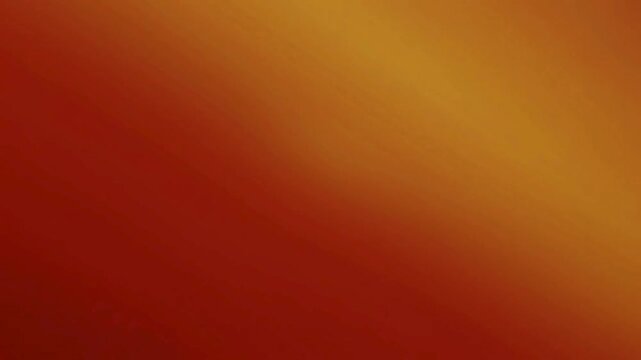 A smooth diagonal gradient transitioning from deep red to warm golden orange, creating a vibrant and abstract background.