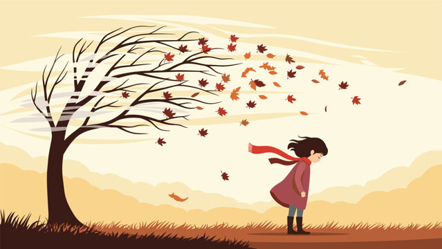 Young girl stands in a windy autumn park while brown leaves blow off a tree and fly through the air on a cold and breezy day.