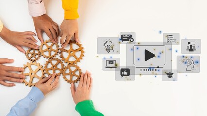 Diverse hands interact with gears and digital media icons, illustrating teamwork and innovation in...