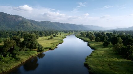 Aerial view of a wide calm river flowing through a lush green valley with rolling hills and scattered trees under a blue sky with clouds