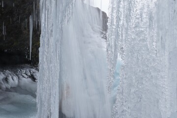 Frozen Selvallafoss Waterfall with Icicles Seen from Behind © Koen