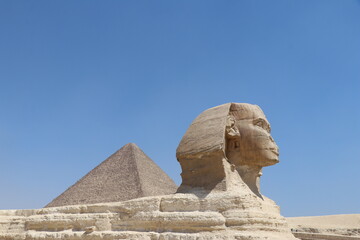 Great Sphinx of Giza with pyramid in desert landscape, Egypt