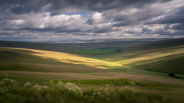 Dramatic landscape with rolling hills and cloudy sky