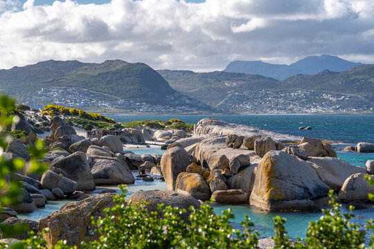 Scenic Boulders Beach with Granite Rocks and Turquoise Water under Mountains in Simon&rsquo;s Town, Cape Town, South Africa
