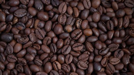 Obraz premium Coffee beans closeup, Roasted beans with shiny surface, Detailed macro shot of aromatic coffee beans, Closeup image showing glossy roasted coffee beans texture and aroma