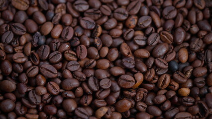 Fototapeta premium Closeup of roasted beans, Detailed view of shiny roasted coffee beans, Macro perspective emphasizing rich brown tones and glossy surface of coffee beans for marketing