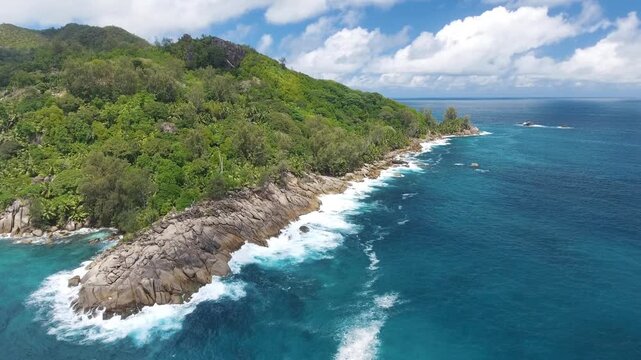 Vacation travel holidays and recreation on beach concept. Tropical beach with sea and palm taken from drone. Praslin island, Seychelles. Slow motion