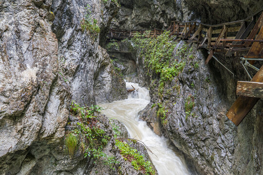 Wooden boardwalk along the Wolfsklamm gorge carved by the Stanserbach River in Tyrol, Austria