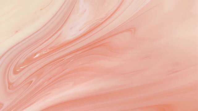 Soft peach colored abstract marble background with swirling patterns.