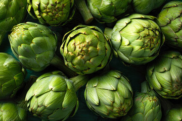 Obraz premium Fresh green artichokes arranged closely on a dark wooden surface, showcasing their unique textures and shapes, ideal for culinary or agricultural themes