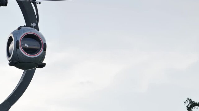 Futuristic spherical cable car pods on a modern aerial ropeway system