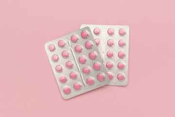 Pink Pills in Blister Packs on Pastel Pink Background: Modern Pharmaceutical Aesthetic