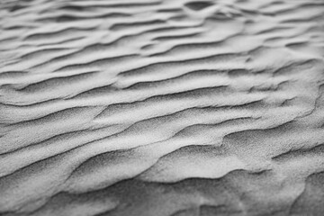 Obraz premium Black and white sand texture closeup natural grain pattern abstract outdoor nature background minimal monochrome surface