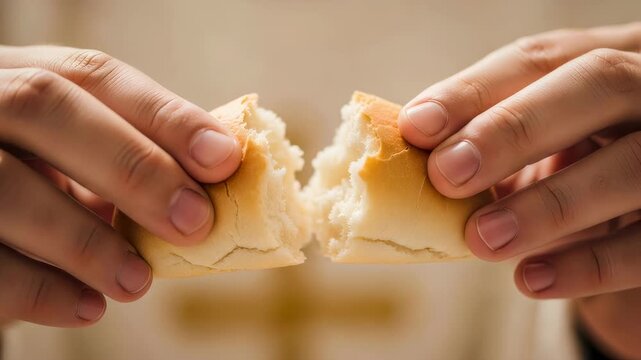 Man tearing bread roll during religious ceremony. Christian communion concept. Breaking sacred bread as part of an Easter ritual.
