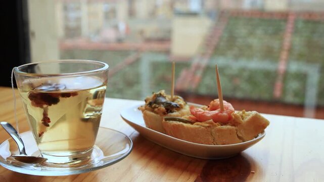 pinchos and tea on the table in Granada, Spain
