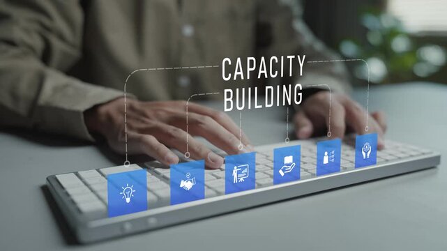 Capacity building concept. Person typing keyboard with professional development and organizational growth icons, skills enhancement, knowledge development and workforce capability improvement.