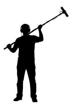 Silhouette of a sound recordist holding a boom microphone during film production.