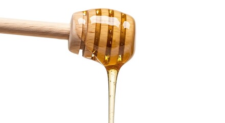 Honey dripping from a wooden honey dipper stick close-up view