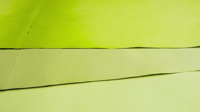 Handmade eco paper sheets dyed with natural vegetable colorants in shades of lime green and pale olive. Textured recycled craft material with a subtle grunge pattern perfect for DIY scrapbooking.