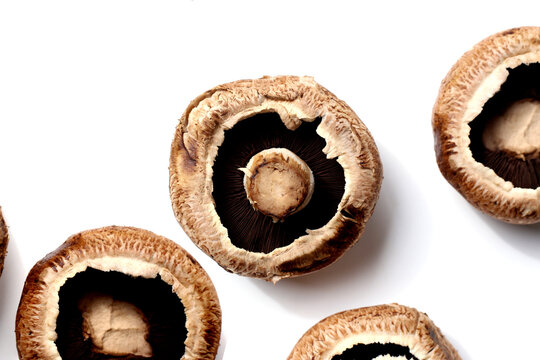 Fresh portobello mushrooms with visible gills underneath.