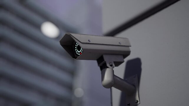 Modern Outdoor Cctv Security Camera Mounted On Building Wall With Blurred City Background