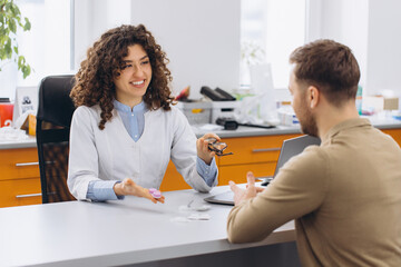 Fototapeta premium Optometrist consulting patient about contact lenses and vision correction options in eye care clinic