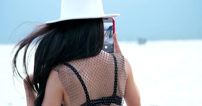 Set of videos showing Vietnamese woman in black bikini and mesh pareo posing, walking, and enjoying Phu Quoc beach, perfect for lifestyle and travel ads.