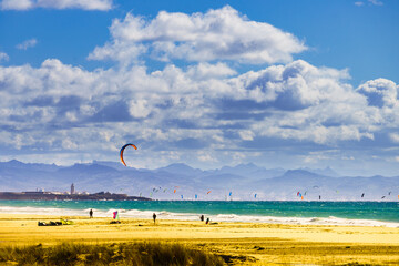Kite surfers riding waves. Kiteboarding sport. Tarifa Spain. © anetlanda