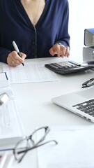 Female financial analysts examining documents, using magnifying glass and calculator while studying corporate data at workplace. Audit and taxes