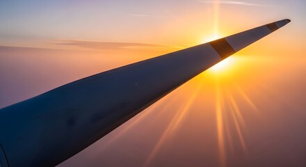 Airplane wing at sunset from inside plane window