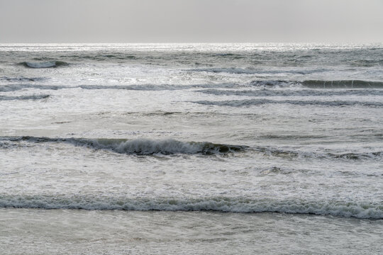 USA, WA, Olympic Peninsula.  Waves lapping at the shore of South Beach