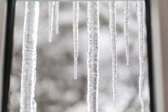 Canada, BC, Delta.  Long icicles outside of a window