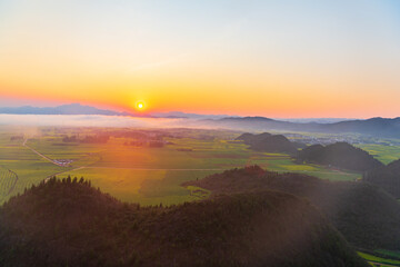 Fototapeta premium Rapeseed flowers at sunset in Jinji Peak Cluster, Luoping, Yunnan