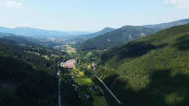 Serene Countryside With Mountains And Forests Visible. Aerial Shot Of Peaceful Valley With Hills And Rivers
