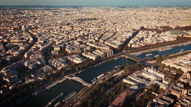 Showcasing the Parisian urban landscape an aerial view of the Paris skyline and the Seine River in France Shot in a Super 8 film style with a blurry handheld retro-film look this stylish b-roll is tra
