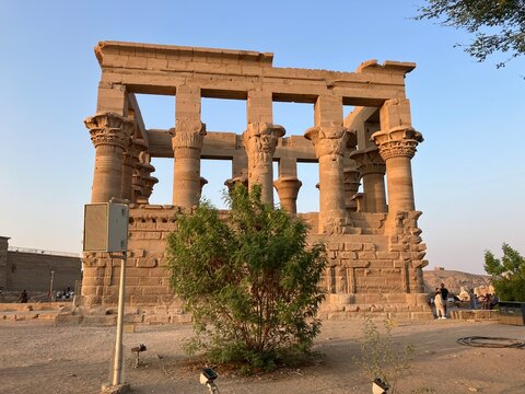 ASWAN, EGYPT - NOVEMBER 7, 2025: Philae Temple dedicated to goddess Isis on Agilkia Island under clear blue sky, historic ancient Egyptian temple complex and major tourist landmark near Aswan