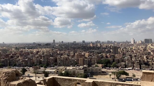 CAIRO, EGYPT - NOVEMBER 15, 2025: Panoramic city view of Cairo seen from the Mosque of Muhammad Ali inside the Citadel of Saladin under clear blue sky