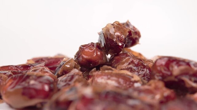 close up of premium dried dates isolated on white. Perfect for Ramadan, healthy snacking, and Middle Eastern food themes