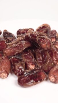 close up of premium dried dates isolated on white. Perfect for Ramadan, healthy snacking, and Middle Eastern food themes