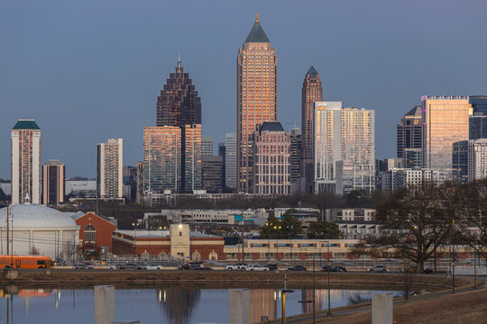 View of the Downtown Atlanta Skyline Cityscape showing several prominent buildings, highways, cars, and hotels after sunset.