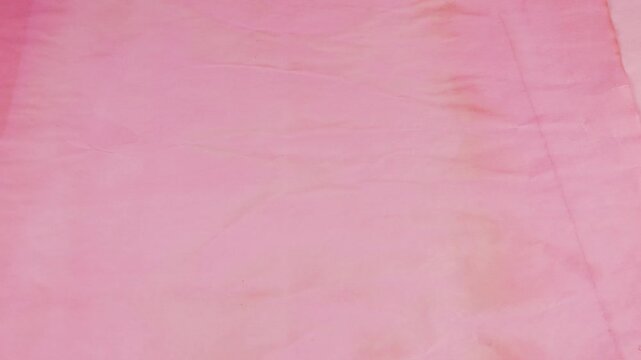 Pink, spring cherry blossom, sakura pink and light pink textured paper sheets with natural, aged effect are layered creating a vintage, abstract background. The handmade paper surface.