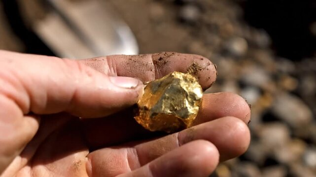 Gold nugget in hand.
