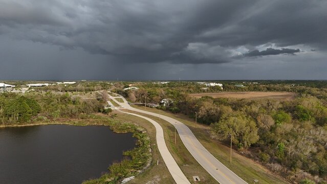 undeveloped commercial land for sale in Lakewood Ranch, Florida before a rainstorm