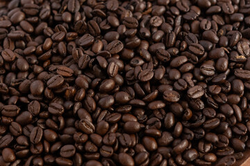 Fototapeta premium Coffee beans photographed from above, with a shine. No people, horizontal image