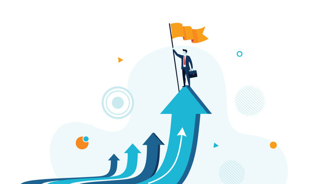 Victorious businessman standing on the tip of a giant blue upward arrow while holding an orange flag to celebrate business growth and success.