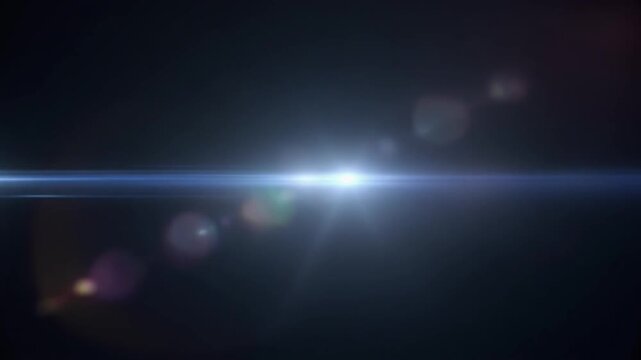 A brilliant light beam shines brightly in the dark space, creating lens flares