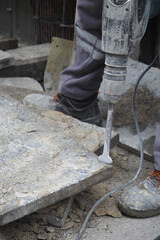Worker using tool at construction site for stone work
